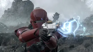 A red-helmeted Helldivers 2 soldier pointing an electro pistol at you on a rocky planet's surface.