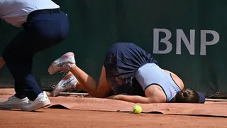 Zeynep Sonmez lies on the court after tripping at the 2026 French Open