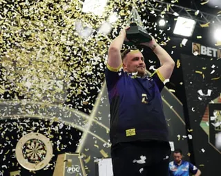 Luke Littler lifts the trophy after winning the Premier League Darts final against Luke Humphries.