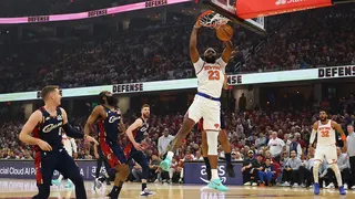 Mitchell Robinson of the New York Knicks dunks the basketball against Jaylon Tyson of the Cleveland Cavaliers.