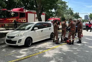 Firefighters at the scene where a 37-year-old engineer was found dead inside a locked car along Jalan Sungai Dua in George Town May 29, 2026. — Social media pic