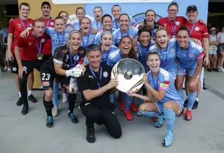 Rado Vidosic and Stephanie Catley hold the A-League Women premiers plate as Melbourne City celebrate their league win