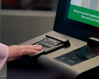A hand on an identity and fingerprint terminal