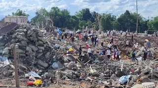 This handout photo provided by Palaung Land shows rescuers and local residents carrying out search operations in the aftermath of an explosion in Kaungtup village in Namhkam township in Shan state, Myanmar on Sunday, May 31, 2026. (Palaung Land via AP)
