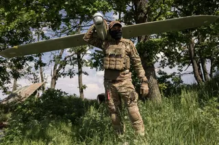 KHARKIV REGION, UKRAINE - MAY 22: (EDITOR'S NOTE: Image has been reviewed by Ukrainian military officials prior to transmission) Member of the Lava Unmanned Systems Regiment, Norman, poses for a photograph with a Leleka reconnaissance UAV, capable of flying up to 120 kilometres and returning to base, on May 22, 2026 in Kharkiv region, Ukraine. The Lava Unmanned Systems Regiment, part of the 2nd Khartiia Corps of the Ukrainian National Guard, is a specialized unit focused on combat operations usi