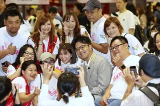民進黨台北市長參選人沈伯洋（中）31日出席「2026愛天使愛心園遊會」，和民眾合...
