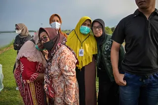 Residents affected by the Lapindo mudflow gather with environmental activists to offers prayers at the embankment of the mud volcano area, marking 20 years since a gas exploration accident triggered a mud flow that inundated more than a dozen villages and permanently displaced tens of thousands of people in Porong, Sidoarjo, East Java province on May 29, 2026. — AFP pic