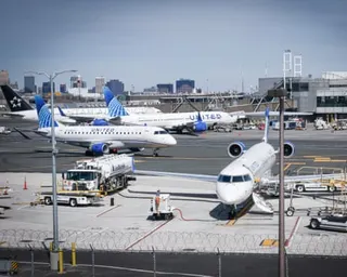blue and white airplanes sit on tarmac at airport during day