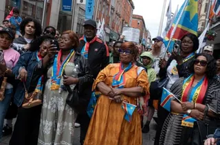 People listen to a speaker during a march for Yves Sakila.