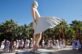Participants dressed as Marilyn Monroe walk near the ‘Forever Marilyn’ statue during the Marilyn Monroe 100th birthday celebration on May 30, 2026 in Palm Springs, California. — Getty Images via AFP