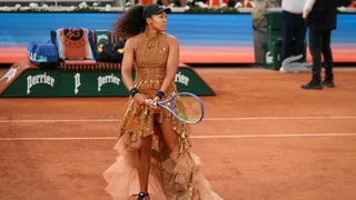 Naomi Osaka warms up in her dress