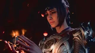A woman in armor with black hair gazes at a glowing puzzle box