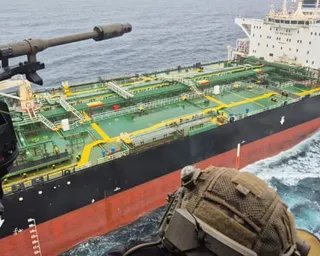The oil tanker, with a navy personnel's head in the foreground