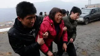 Getty Images Relatives of trapped coal mine workers are taken away from the site of a flooding accident at a mine in Shanxi province on March 29, 2010.