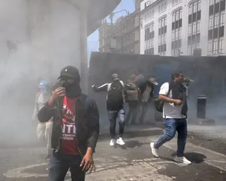 people stand outside in a cloud of smoke
