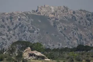 Reuters A destroyed house in southern Lebanon, with Beaufort Castle in the background, as seen from northern Israel (2 June 2026)