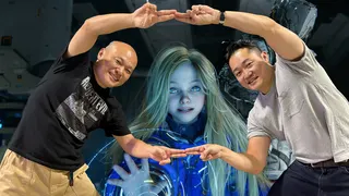 RE Requiem Koshi Nakanishi (left) poses with Pragmata director Yonghee Cho (right), superimposed over a screenshot of Diana from Pragmata