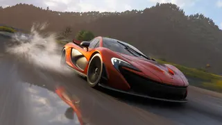 Forza Horizon 6 best cars: A McLaren P1 driving down a wet road towards the camera, spraying water behind it.
