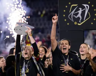 The Portland Thorns lift the championship trophy at the 2022 final at Washington's Audi Field.