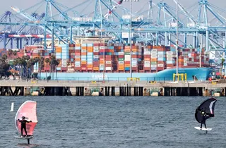 People ride wing foils near a container ship at the Port of Los Angeles on Thursday. Photo: AFP