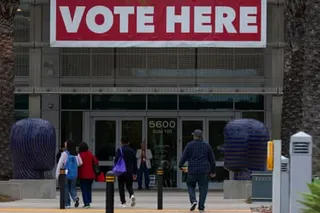 People arrive to drop off their election ballots or vote during the California primary election in San Diego on Tuesday.