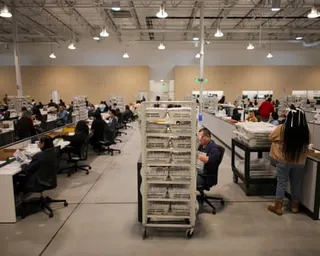 Election workers process ballots during the California primary election in City of Industry, California.