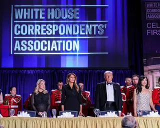 people stand at a table under a backdrop that reads 'White House correspondents association'