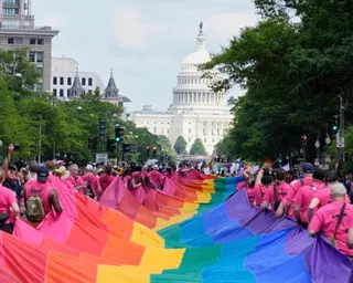 a group carries a rainbow Pride flag