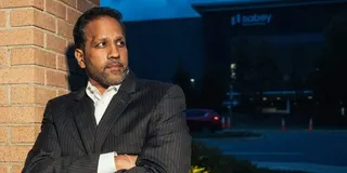 Mital Gandhi poses for a photo in front of a data center, near The Regency, the community where he lives in Ashburn, Virginia in the heart of Data Center Alley.