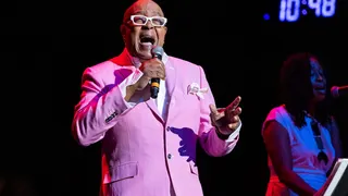 Peabo Bryson singing on stage at Michigan Lottery Amphitheatre