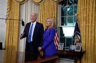 Joe Biden gestures while standing beside Jill Biden in the Oval Office
