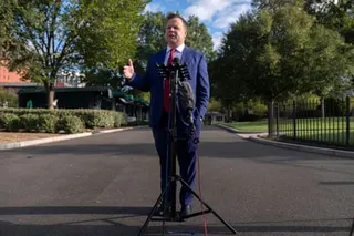a man speaks into a microphone outside