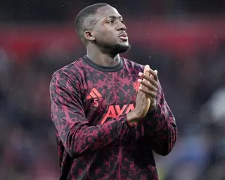 Ibrahima Konate in a warm-up jersey claps the Liverpool crowd