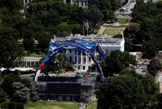 Workers continue building the cage for a future UFC fight on the South Lawn of the White House on Wednesday. Photo: AP