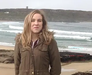 Natalie McNally smiling on a beach.