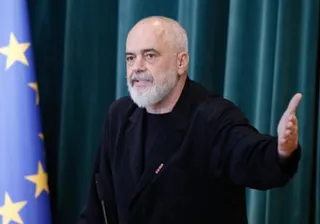 Albanian prime minister Edi Rama gestures next to an EU flag
