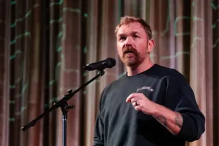 a man in front of a microphone