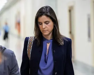 a woman walks in a corridor