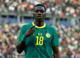Sarr holds his finger out in celebration