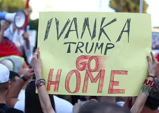 Protesters hold up a banner reading ‘Ivanka Trump Go Home’