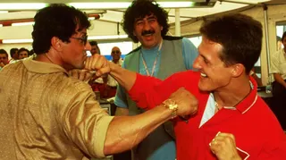 Actor Sylvester Stallone and Ferrari's Michael Schumacher pretend to box in 1998