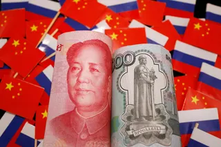 Yuan and Russian rouble banknotes are seen amid flags of China and Russia in this illustration picture taken on September 15, 2022. Photo: Reuters