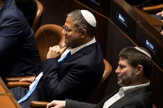 JERUSALEM, ISRAEL - DECEMBER 29: Designated Minister of National Security Itamar Ben Gvir (L) and designated Israeli Minister of Finance Bezalel Smotrich (R) react at the Israeli parliament during a new government sworn in discussion at the Israeli parliament on December 29, 2022 in Jerusalem, Israel. Conservative Benjamin Netanyahu and a bloc of nationalist and religious parties won a clear election victory last month and will be sworn in as government to the Knesset today. This completes Neten