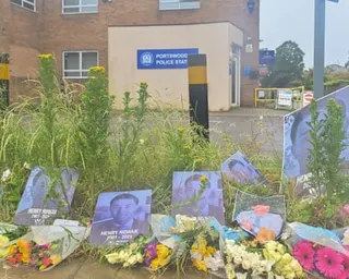 Floral tributes and photographs are laid outside Portswood Police Station