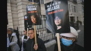 Protesters hold placards as they gather for a 'solidarity action' outside the Chinese Embassy in London on November 8, 2025, in support of the Hong Kong Alliance defendants. A Hong Kong court ruled last week that it will go ahead with the national security trial of three Tiananmen activists, leaders of the now-disbanded vigil organiser group -- known as the Hong Kong Alliance in January, rejecting a last-ditch application to toss out the case. Vigils have been banned since 2020, when Beijing imp
