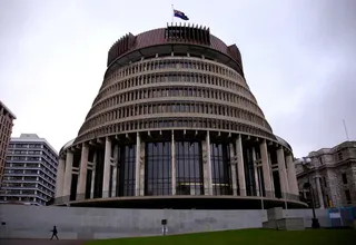 This file picture shows a pedestrian walks past the New Zealand parliament building known as the Beehive in central Wellington, New Zealand. — Reuters pic