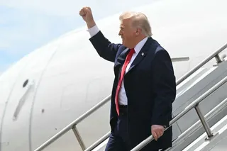 US President Donald Trump raises his fist as he disembarks from Air Force One at Chippewa Valley Regional Airport in Eau Claire, Wisconsin, on June 5, 2026.