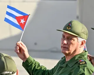 Cuba's President Miguel Diaz-Canel waving a flag