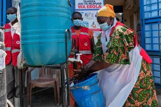 A health worker washes her hands at a temporary health clinic at the Mpondwe border crossing linking Uganda and the Democratic Republic of the Congo, Thursday, June 4, 2026. (AP Photo/Hajarah Nalwadda)