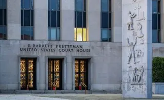 a photo outside the front doors of the E. Barrett Prettyman United States Court House in Washington, D.C., home to the United States District Court for the District of Columbia